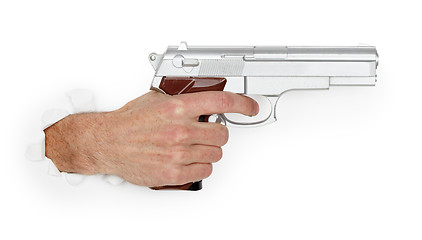 Image showing Man's hand holding a large silver handgun