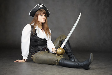 Image showing Young beautiful woman in clothes of pirate with sabre
