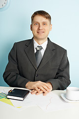Image showing Businessman sitting in an office at table