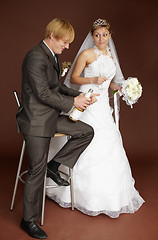 Image showing Bridegroom opens champagne wine