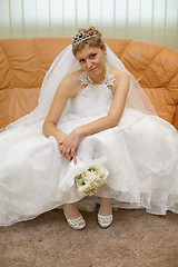 Image showing Bride sitting on sofa waiting for ceremony