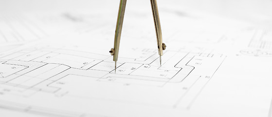 Image showing Metal compasses against engineering drawing