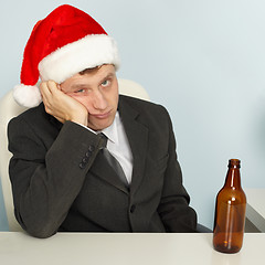 Image showing Sad man suffering from hangover after Christmas