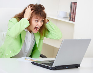 Image showing Enraged woman reads news in Internet