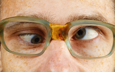 Image showing Cross-eyed person in old-fashioned spectacles