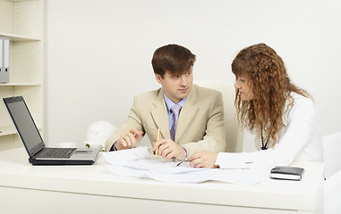 Image showing Young businessmen on a workplace  in office