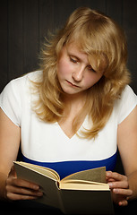 Image showing Young girl reading a book