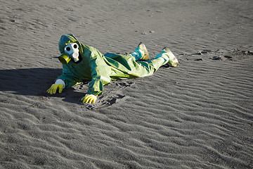 Image showing Man in gas masks crawling on poisoned soil