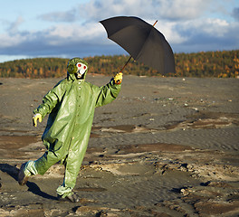 Image showing Person in protective scientific overalls with umbrella