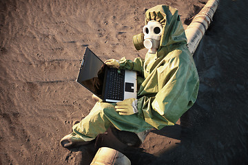 Image showing Scientist with laptop in zone of ecological disaster