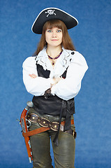 Image showing Woman - sea pirate on blue background with pistol