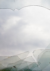 Image showing View through broken window at cloudy sky