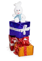 Image showing Toy rabbit, and Christmas gifts on white