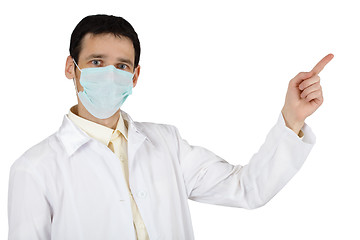 Image showing Young man in medical mask points finger