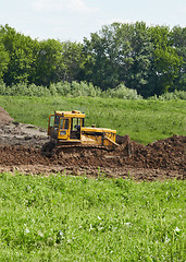 Image showing Old caterpillar tractor works in fields