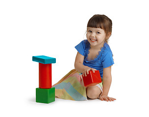 Image showing Little girl playing with color toys isolated on white background