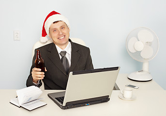 Image showing Businessman gets drunk at office before new year