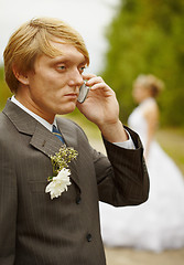 Image showing Groom speaks by phone , forgotten about bride