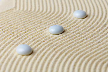 Image showing Art composition from white stones on yellow sand