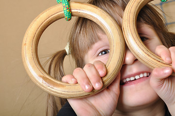 Image showing child playing at gymnastic rings
