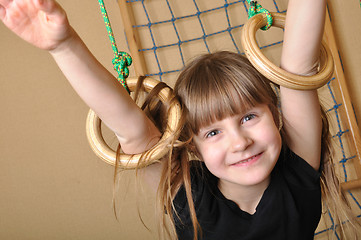 Image showing child playing at gymnastic rings