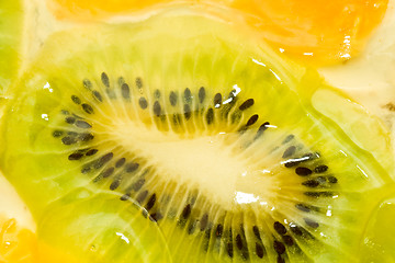 Image showing Sliced kiwi, orange background