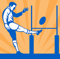 Image showing Rugby player kicking ball at goal post