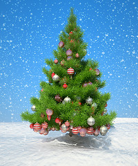 Image showing Firtree with Xmas decoration during snowfall