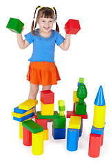 Image showing Cheerful girl playing with colored blocks