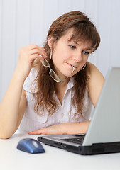 Image showing Woman reading from screen of laptop