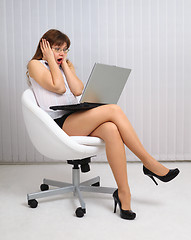 Image showing Woman in horror looking at laptop screen