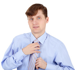 Image showing Young man adjusts his tie