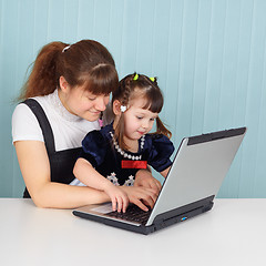 Image showing Mom teaches daughter to use computer