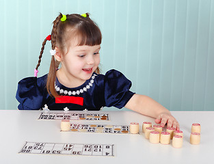 Image showing Child playing with bingo at the table