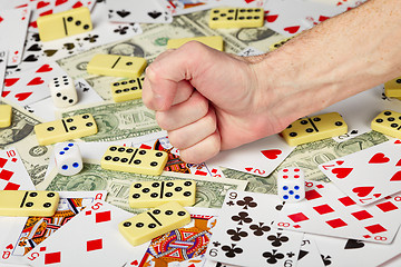 Image showing Hand clenched in a fist and playing cards