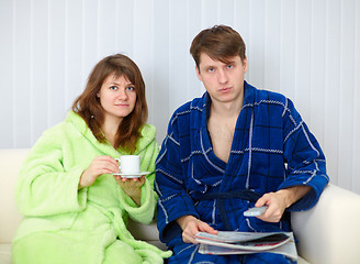 Image showing Couple sit on sofa and watching TV in disgust