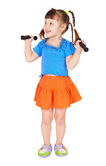 Image showing Girl in dress with dumbbells in hands on white background