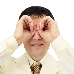 Image showing Businessman looking through fingers like a pair of binoculars