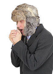 Image showing Freezing businessman in fur hat on white background