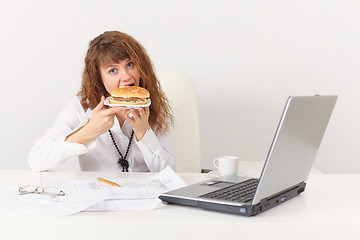 Image showing Young woman eagerly have a sandwich