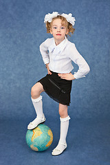Image showing Girl set foot on globe like a soccer ball