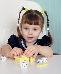 Image showing Happy beautiful child plays with toys on table