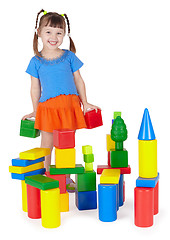 Image showing Child happily playing with colored blocks