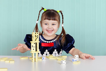 Image showing Little happy girl is playing with toys