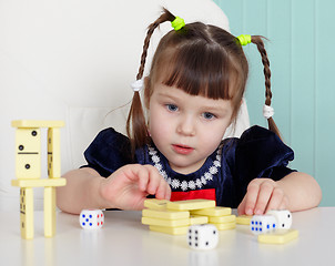 Image showing Child playing with small toys at table