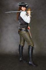 Image showing Woman dressed as pirate on black with sword