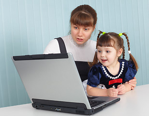 Image showing Mother teaches daughter to use computer