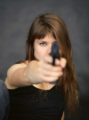 Image showing Woman aiming in enemy from pistol