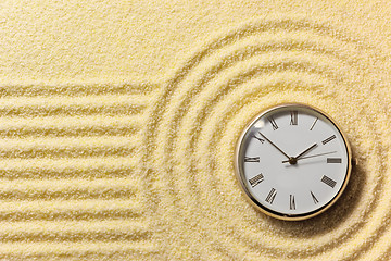 Image showing Old watch on surface of golden sand