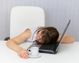 Image showing Woman was tired and sleeping on keyboard of laptop